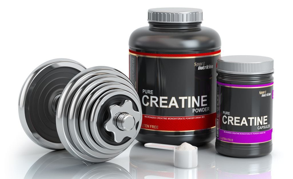 Creatine containers next to barbell